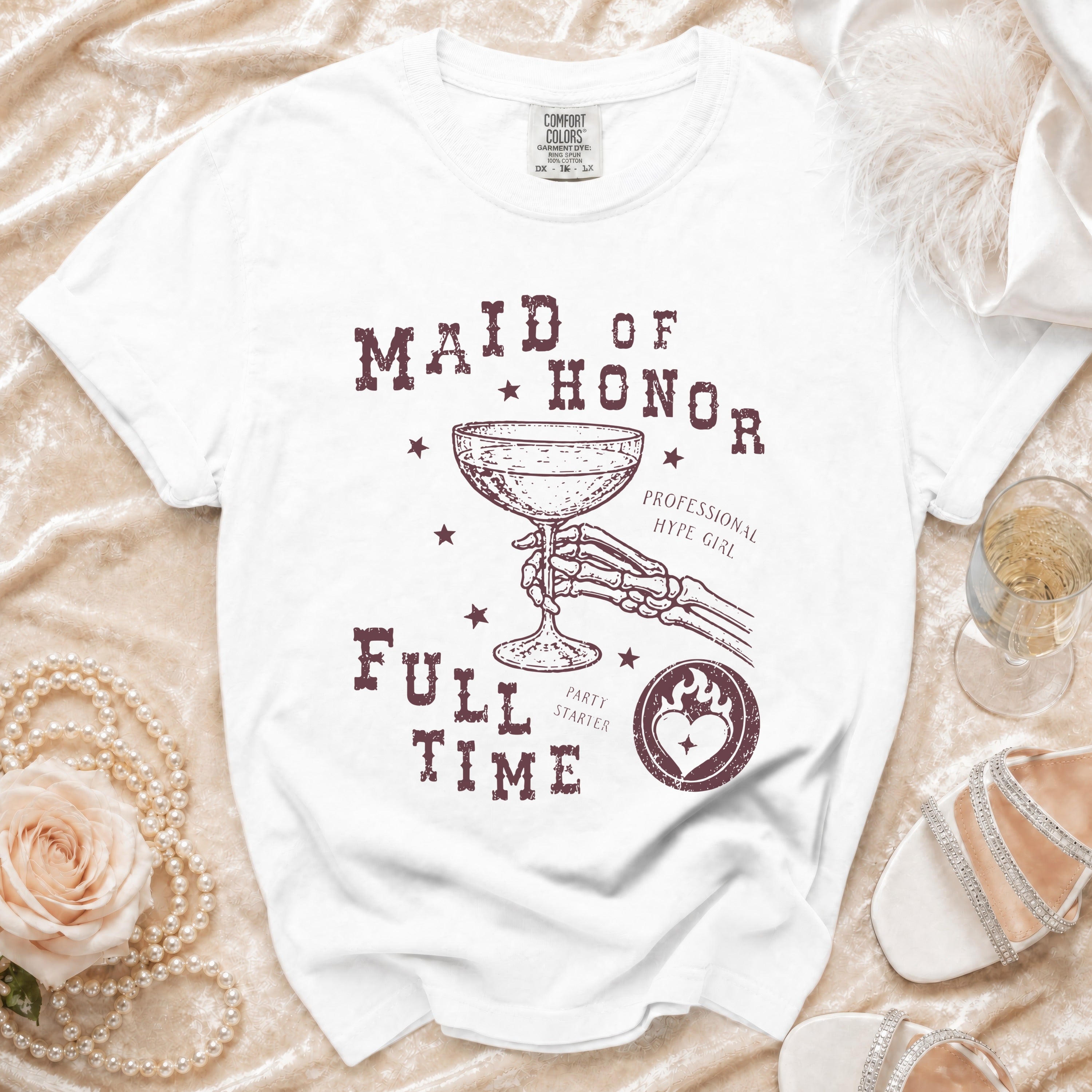 White t-shirt with "Maid of Honor Full Time" graphic and skeleton hand holding champagne.