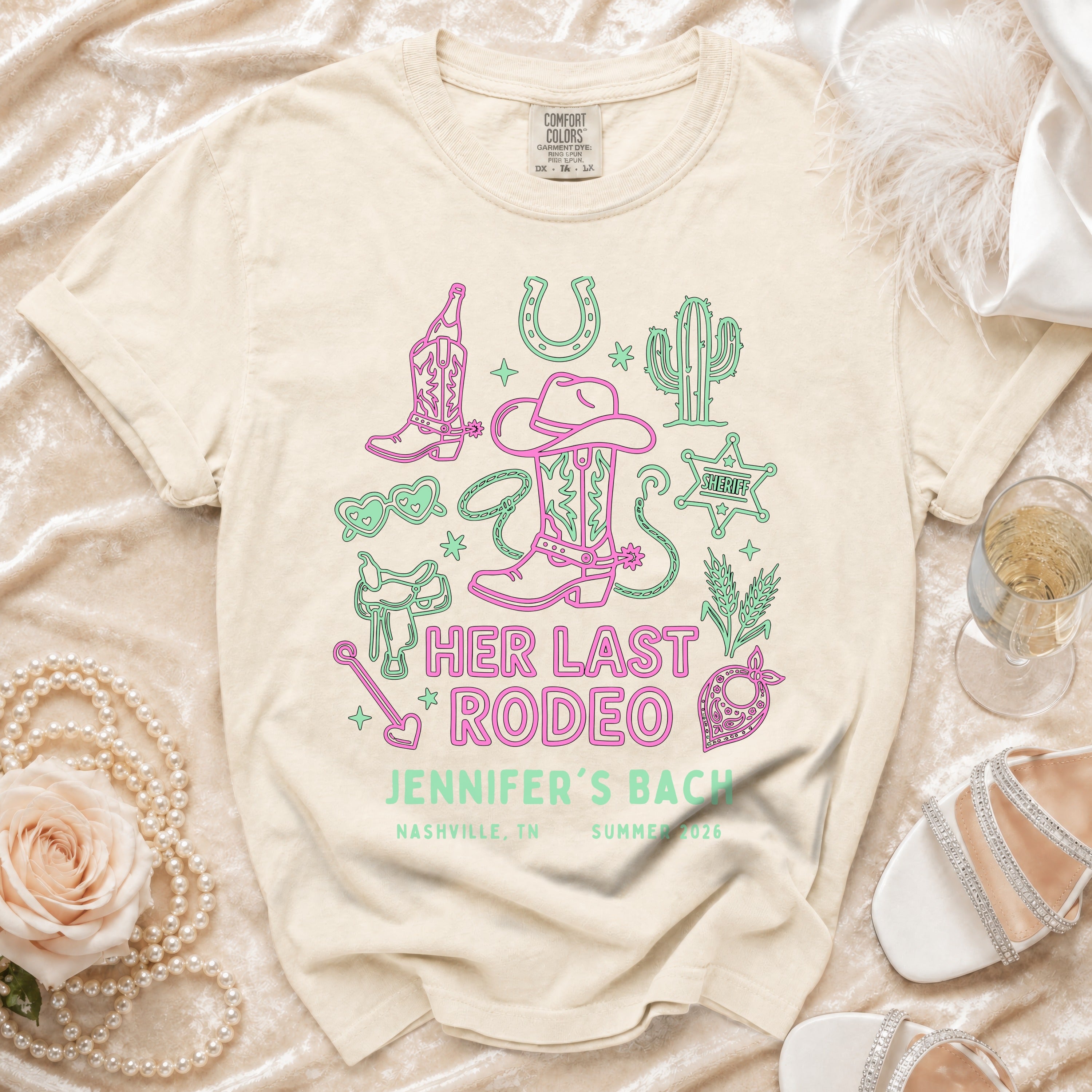 Cream t-shirt with "Her Last Rodeo Jennifer's Bach" text and Western graphics.