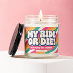 Glass candle with lit wick and "MY RIDE OR DIE! MY MAID OF HONOR" label.