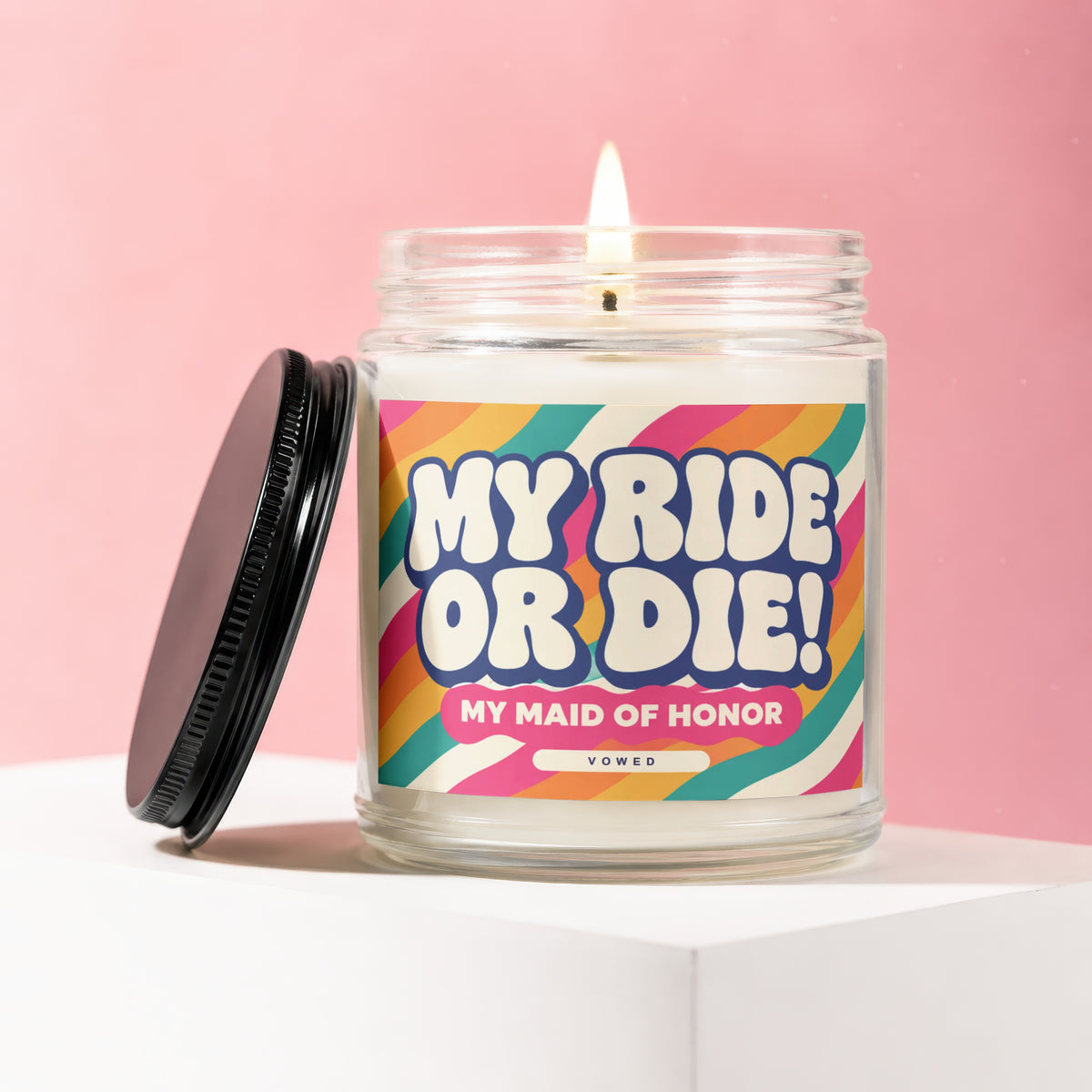 Glass candle with lit wick and "MY RIDE OR DIE! MY MAID OF HONOR" label.