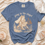 Blue t-shirt with a cat bride riding a frog with the text "going to the chapel est. 2026".