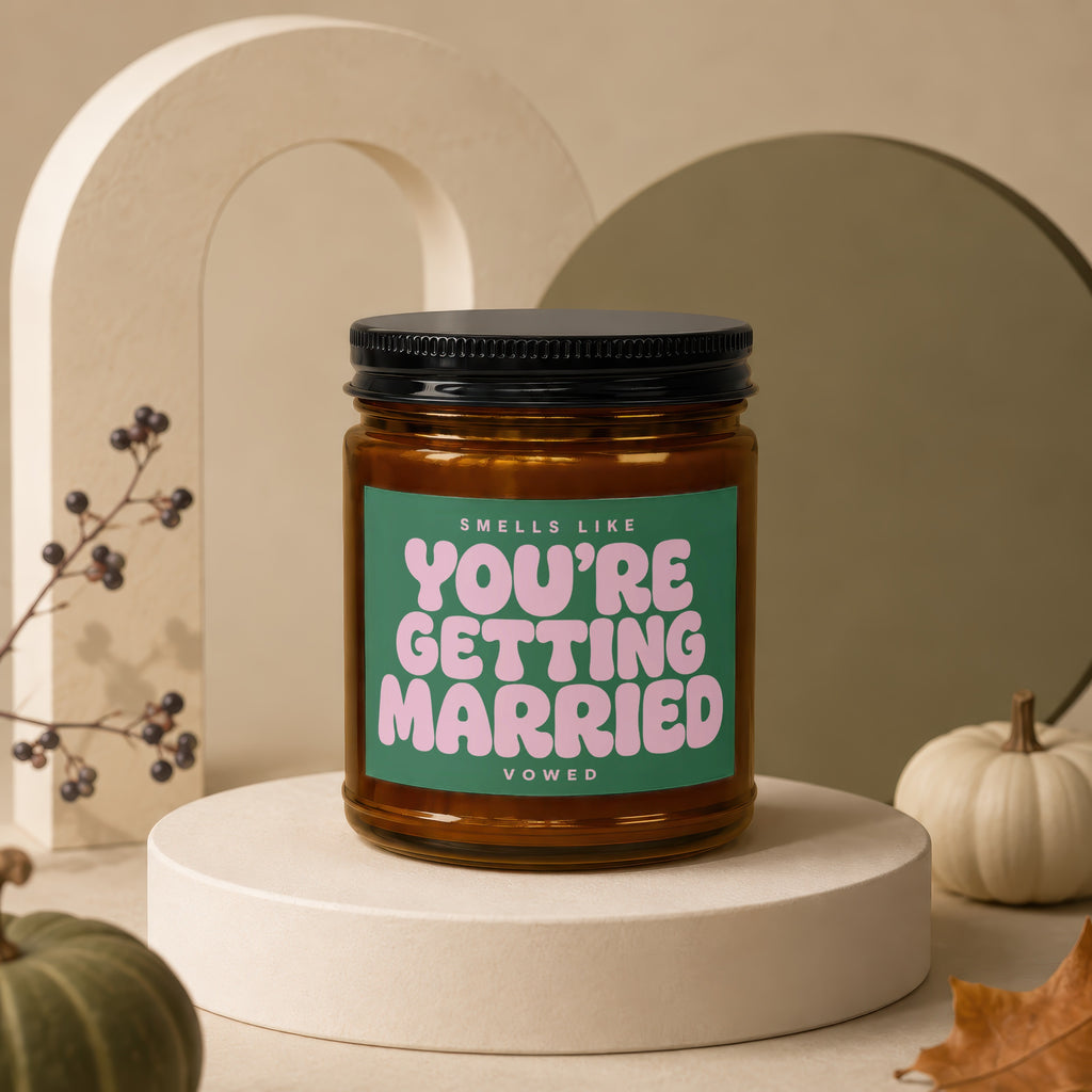 Amber jar candle with "YOU'RE GETTING MARRIED" on a green label.