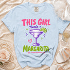 Light blue t-shirt with "This Girl Needs a Margarita" text and margarita graphic.
