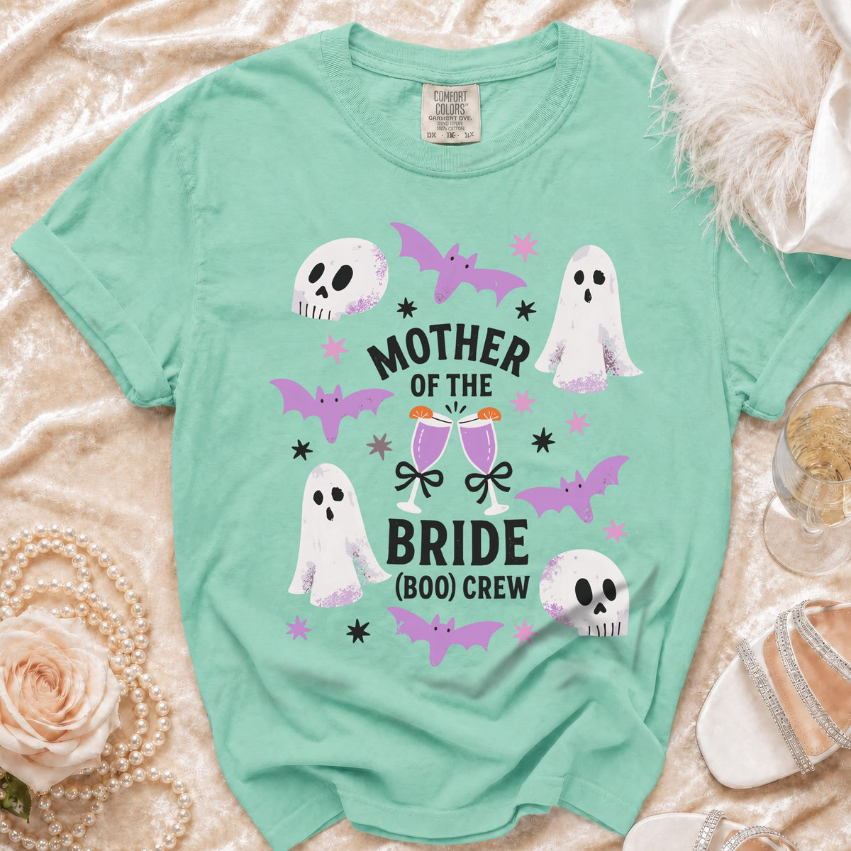 Mint green t-shirt with "Mother of the Bride (Boo) Crew" text, ghosts, skulls, and bats.