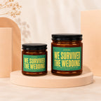 Two amber glass jars with black lids, labeled "We Survived The Wedding".