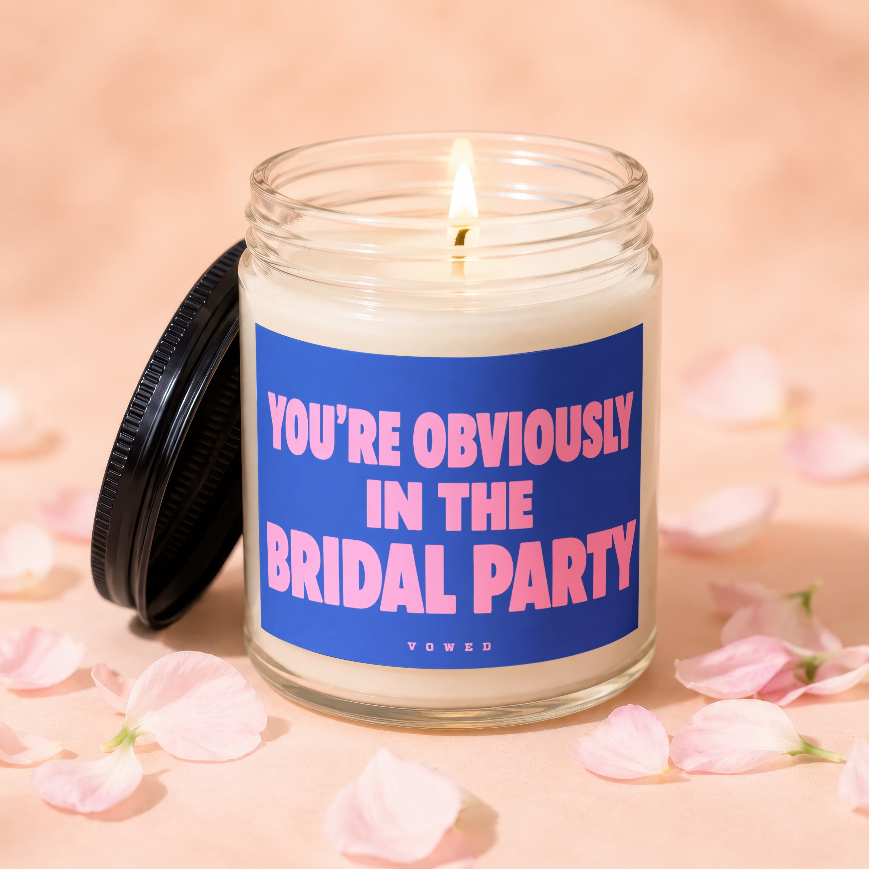 Glass candle with blue label reading "YOU'RE OBVIOUSLY IN THE BRIDAL PARTY."