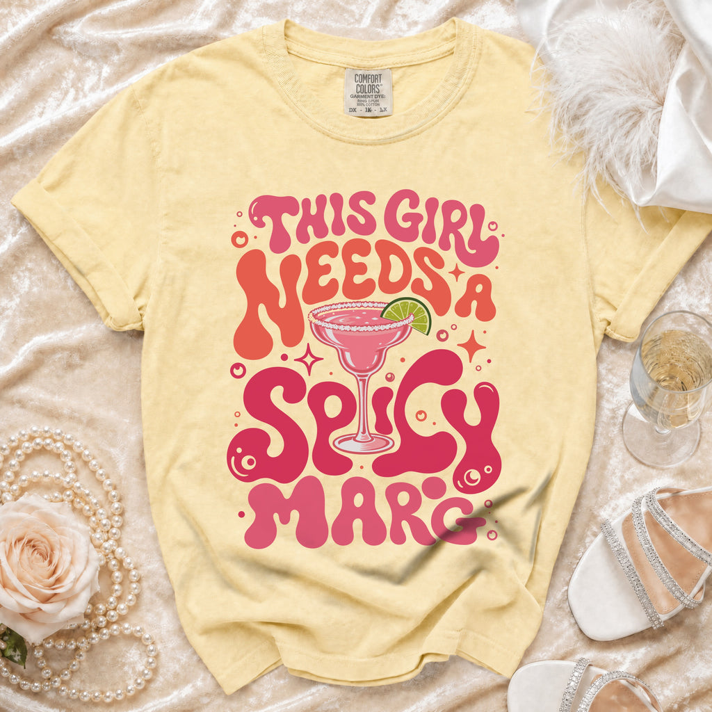 Yellow t-shirt with "This girl needs a spicy marc" text and margarita graphic.