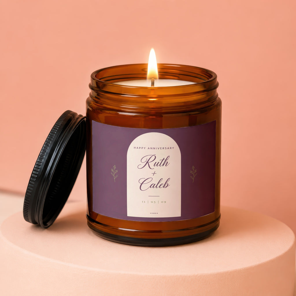 Amber jar candle with lit flame, labeled "Happy Anniversary Ruth + Caleb 11 | 03 | 09".