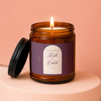 Amber jar candle with lit flame, labeled "Happy Anniversary Ruth + Caleb 11 | 03 | 09".