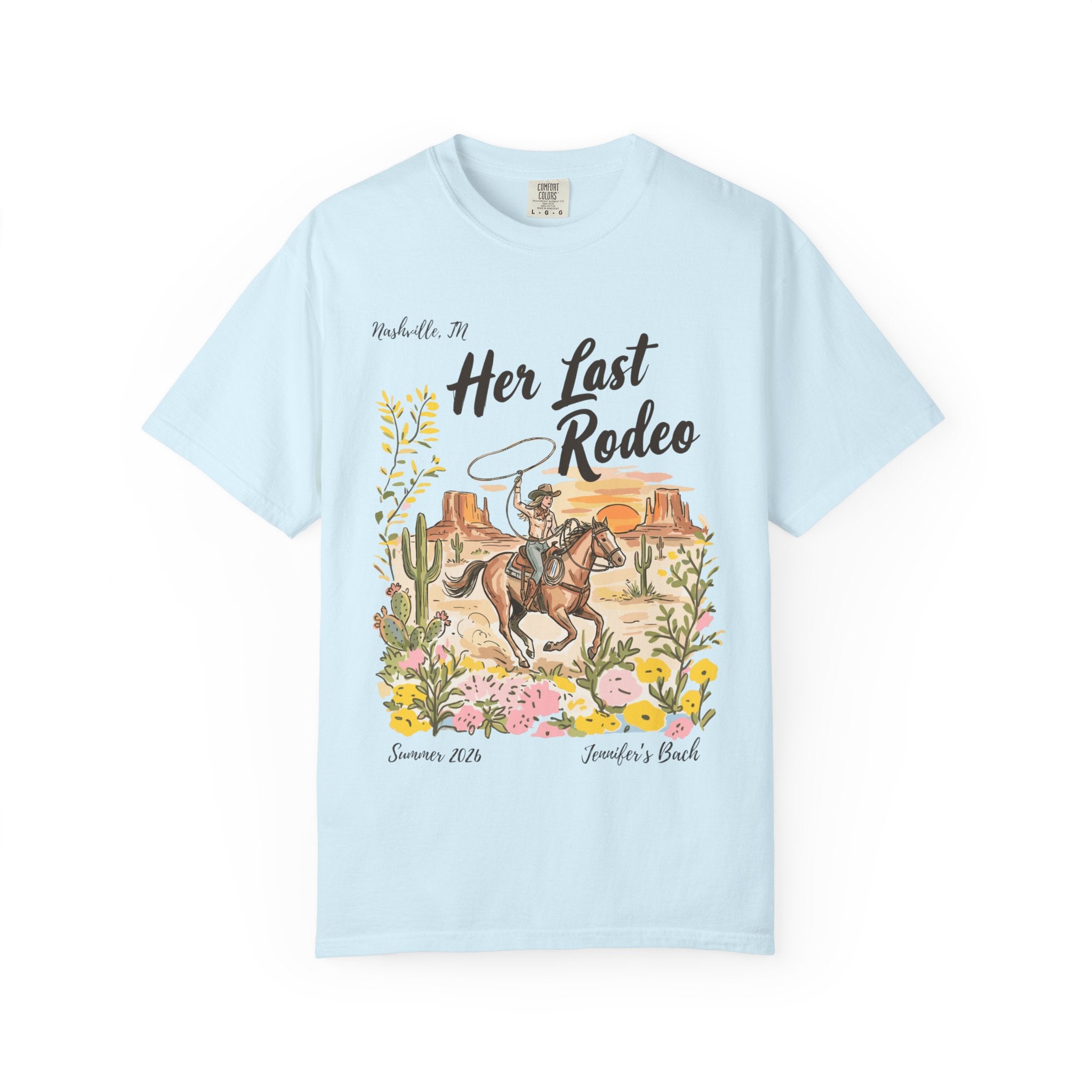 Light blue t-shirt with "Her Last Rodeo" and desert scene graphic.