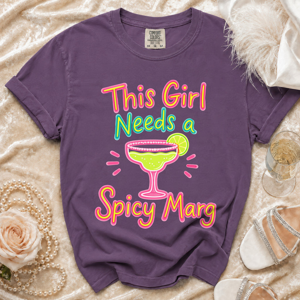 Purple t-shirt with multicolor graphic saying "This Girl Needs a Spicy Marg".