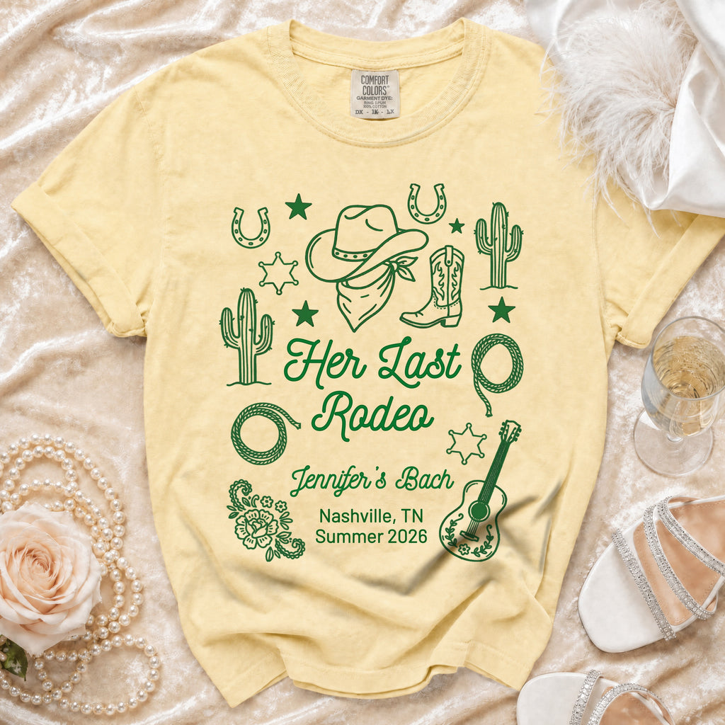 Pale yellow t-shirt with "Her Last Rodeo" graphic, floral, and cowboy elements.