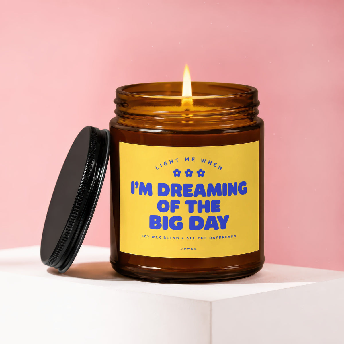 Amber jar candle with yellow label reading "I'M DREAMING OF THE BIG DAY".