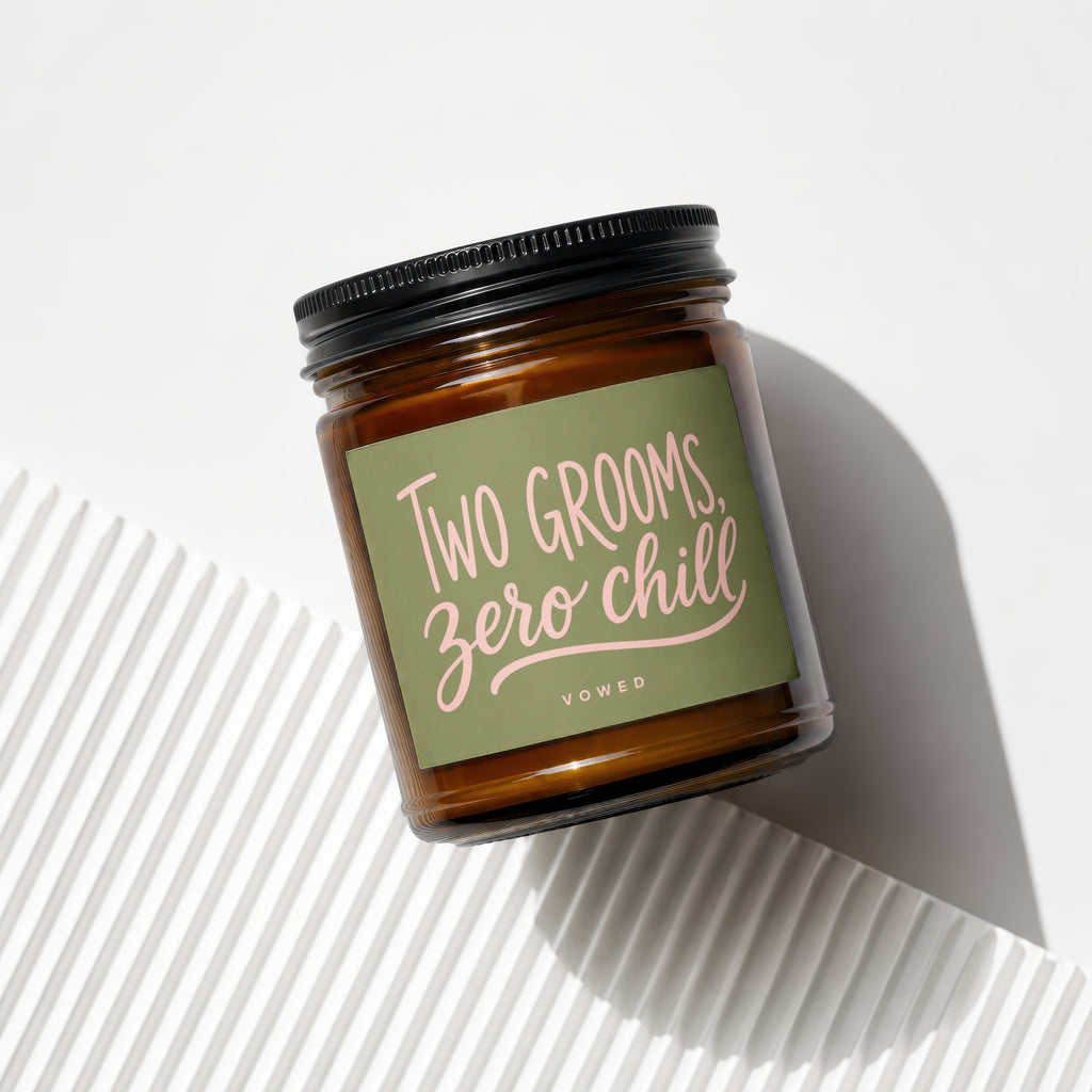 Brown glass jar candle with "Two Grooms, Zero Chill" sentiment and "vowed" text.