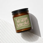 Brown glass jar candle with "Two Grooms, Zero Chill" sentiment and "vowed" text.