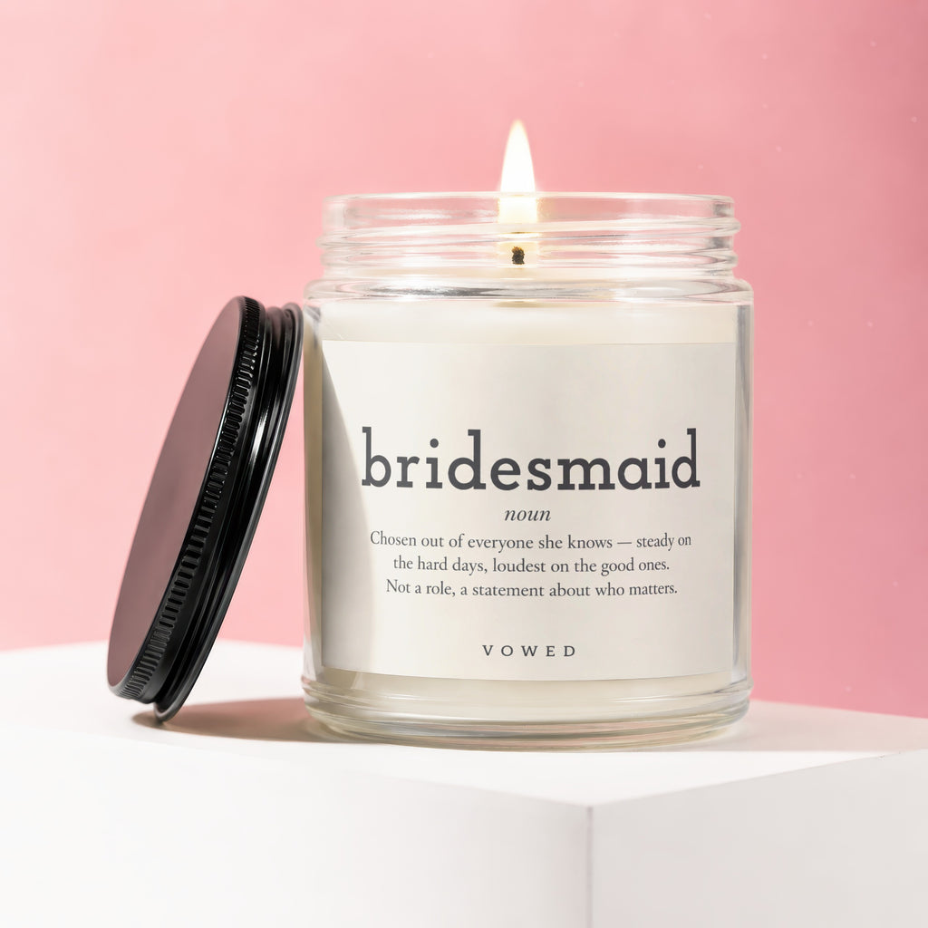 Candle in glass jar with black lid, featuring "bridesmaid" definition label.