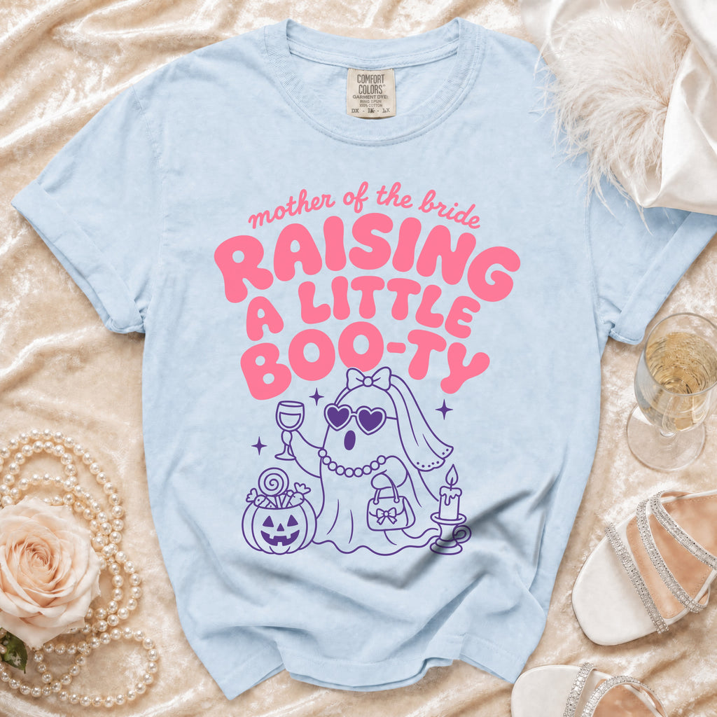 Light blue t-shirt with pink text "mother of the bride RAISING A LITTLE BOO-TY" and a cartoon ghost.