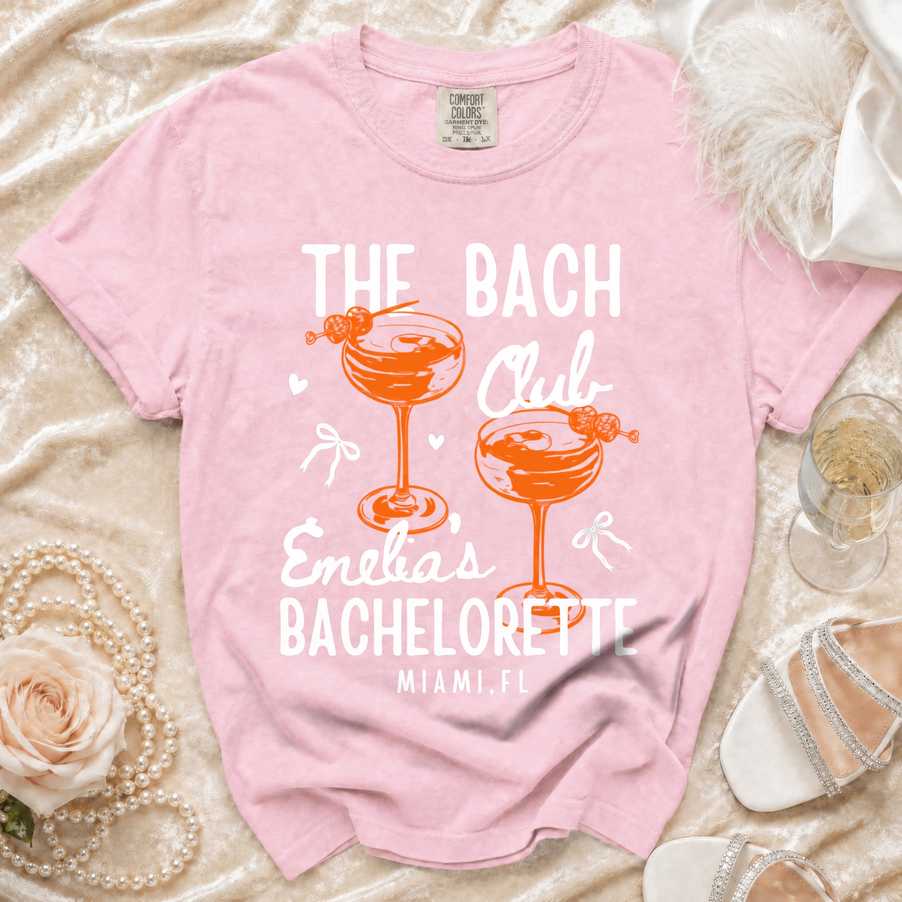 Pink t-shirt with "The Bach Club Enelia's Bachelorette Miami, FL" text.