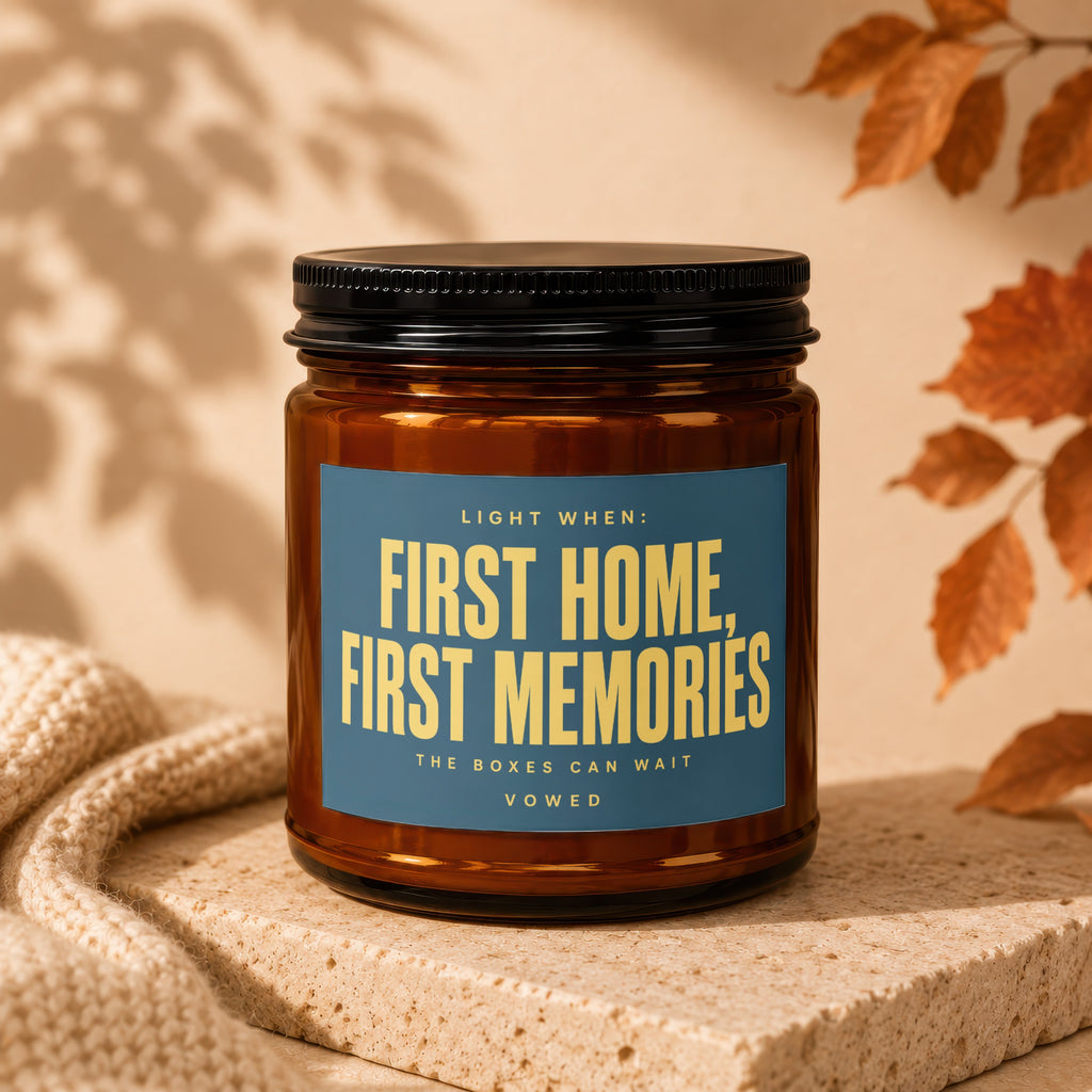 Amber candle with "First Home, First Memories" text on blue label.