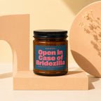 Amber glass candle with a blue label reading "Open in Case of Bridezilla".