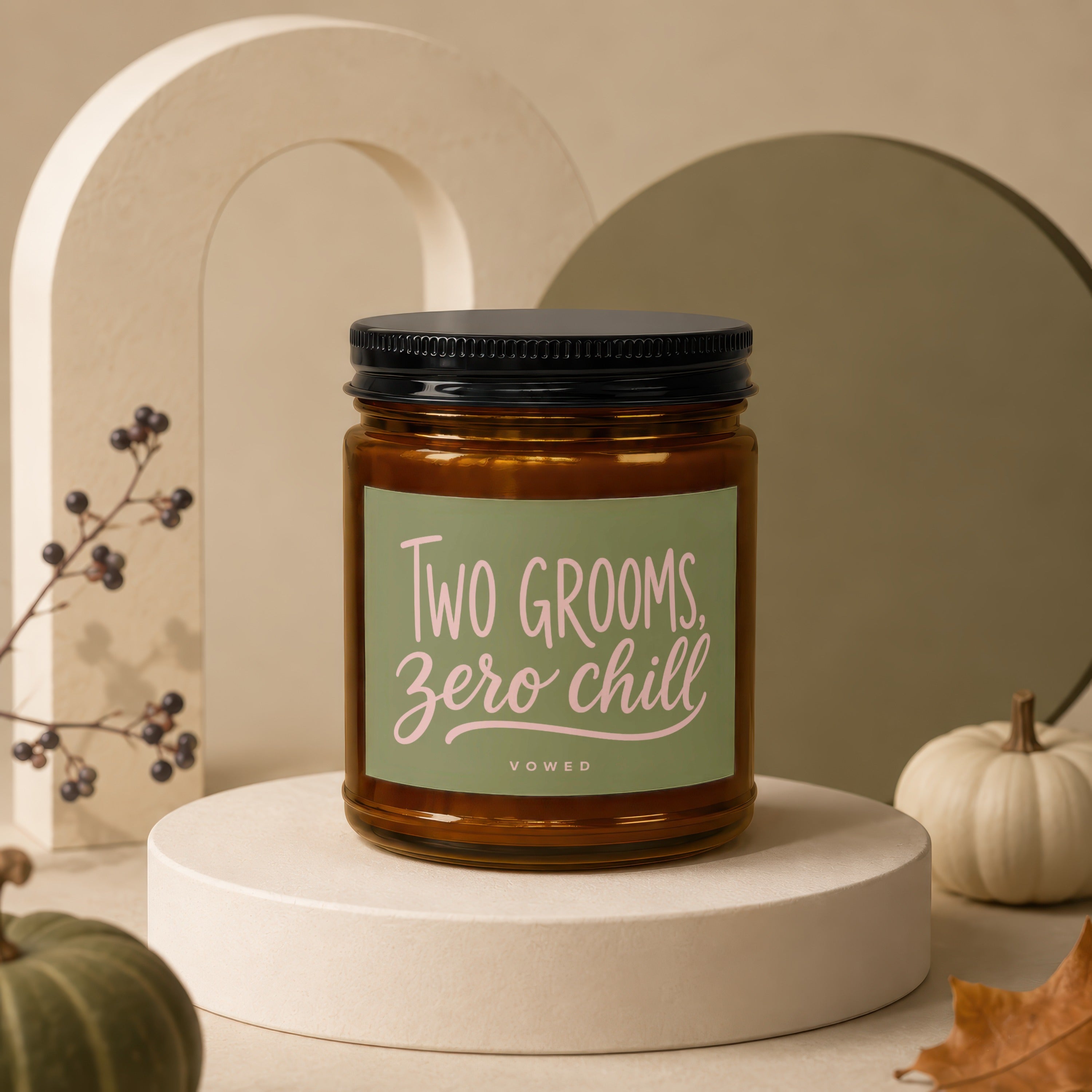 Amber jar candle with a green label that reads "TWO GROOMS, ZERO CHILL, VOWED".