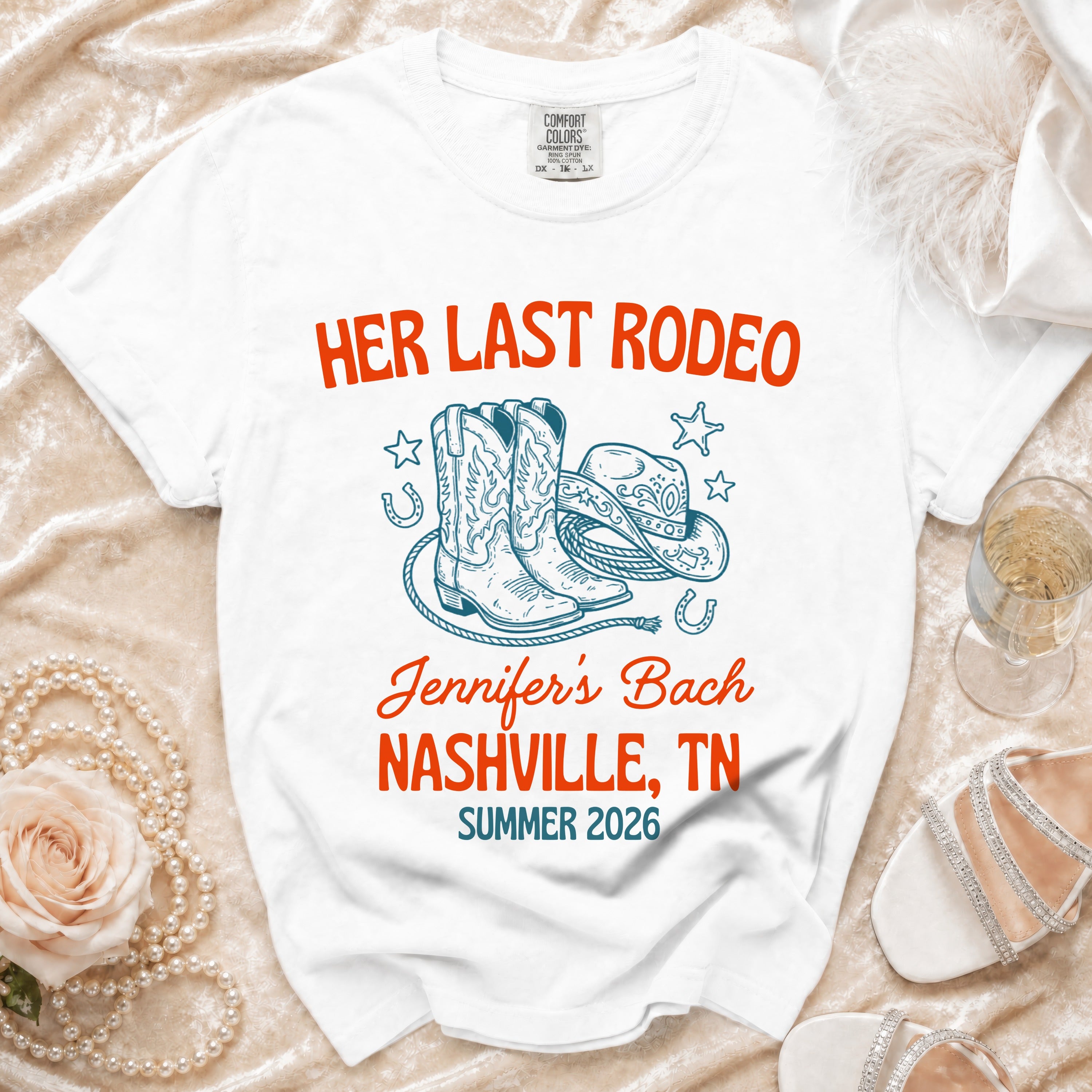 White t-shirt with "Her Last Rodeo Nashville, TN Summer 2026" text and cowboy boots.