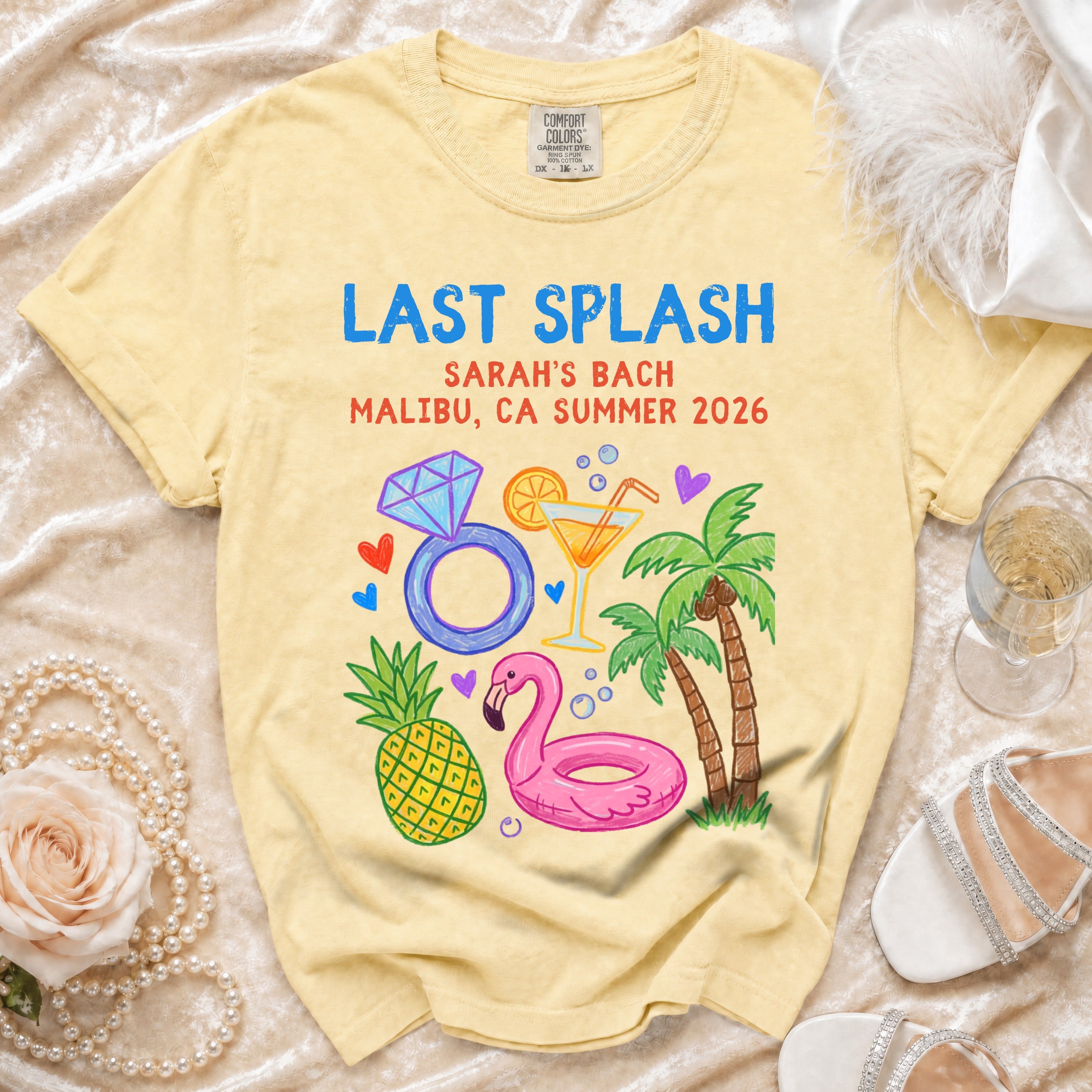 Sarah's Bach Malibu CA Summer 2026 "Last Splash" graphic tee with pineapple, flamingo, palm trees, cocktail.