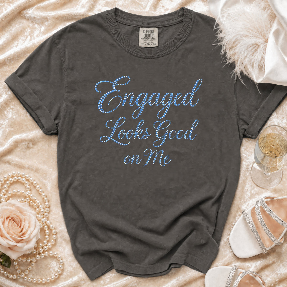Dark grey t-shirt with "Engaged Looks Good on Me" text in blue dots.