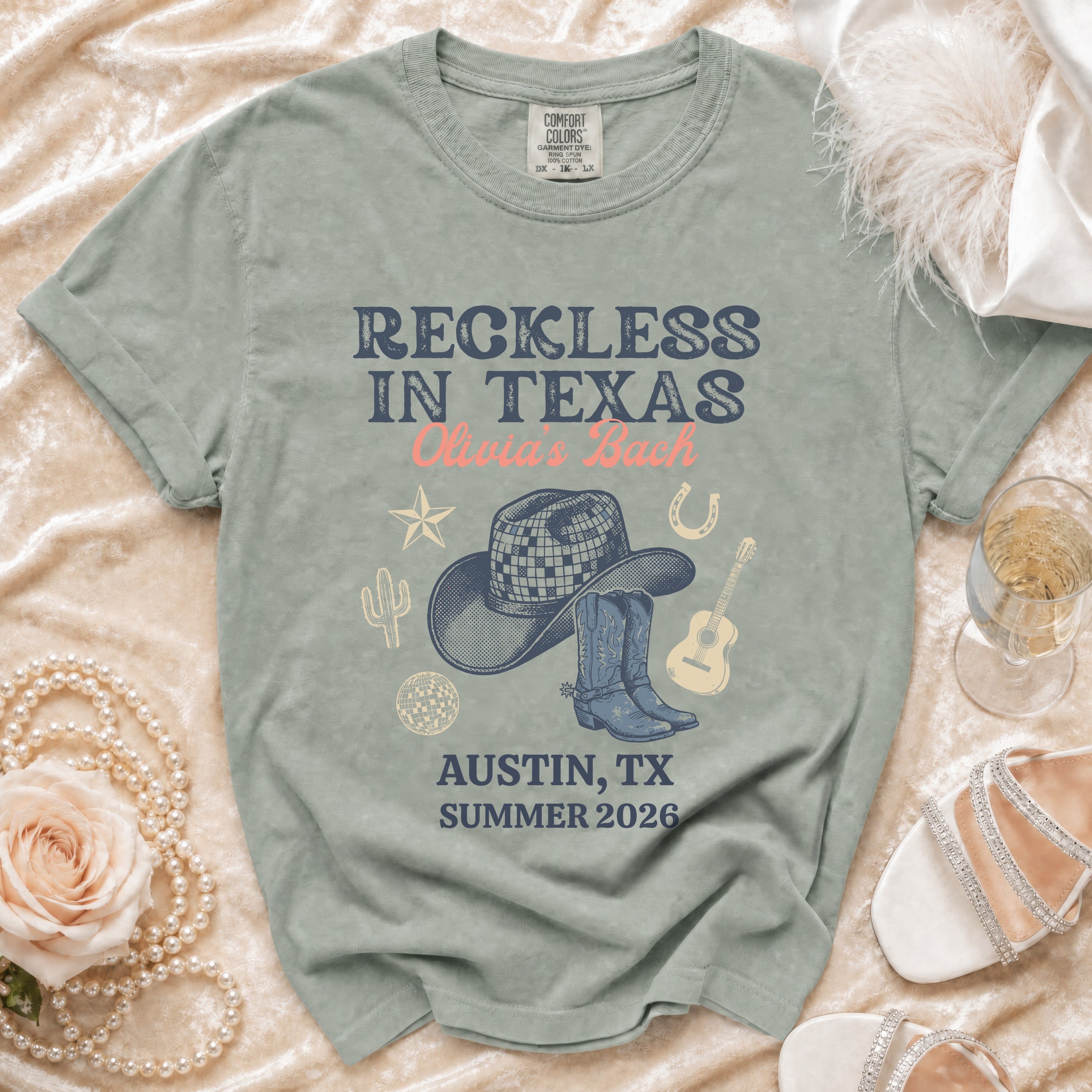 Comfort Colors t-shirt: "Reckless in Texas Olivia's Bach" with Texas icons.