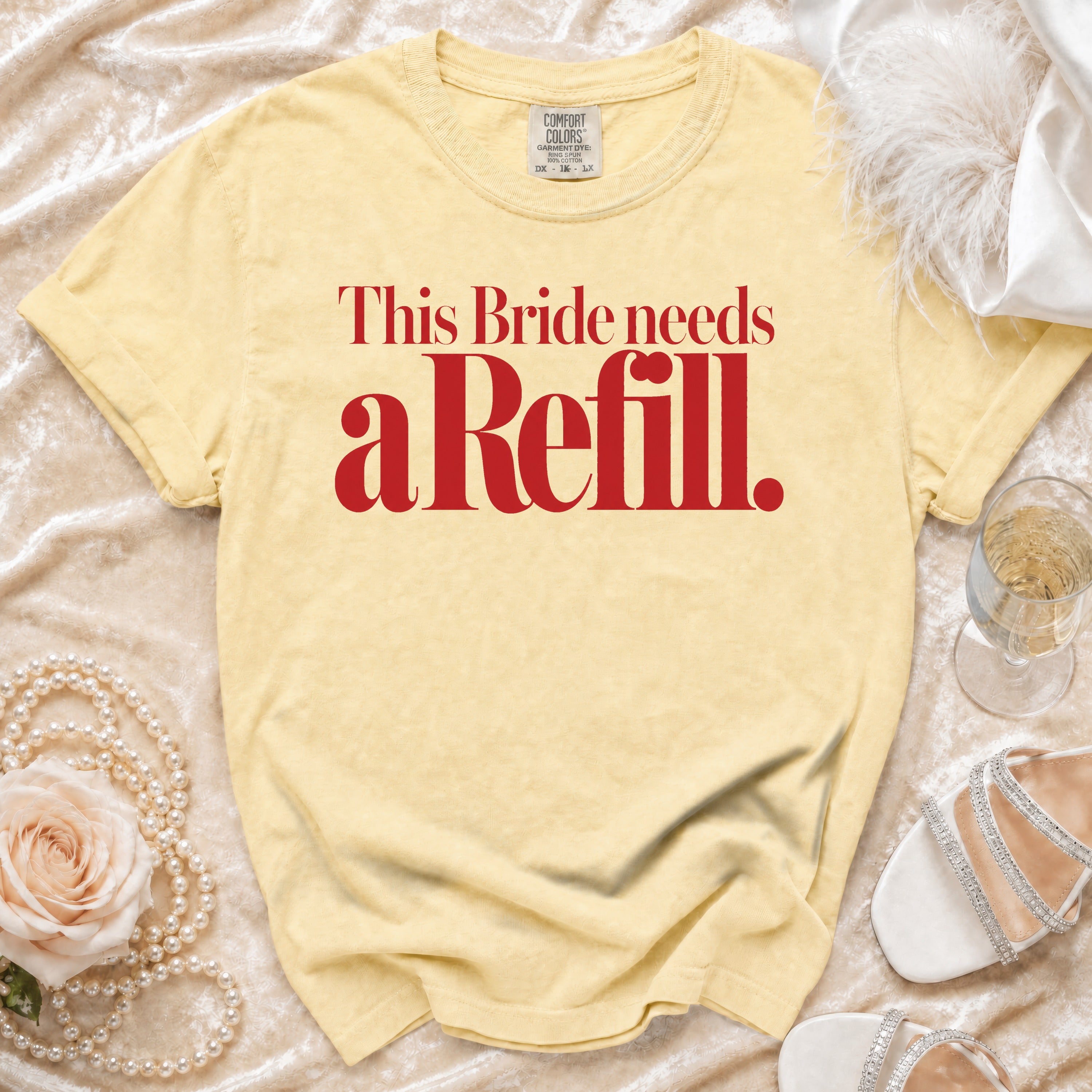 Yellow t-shirt with red text that reads "This Bride needs a Refill."