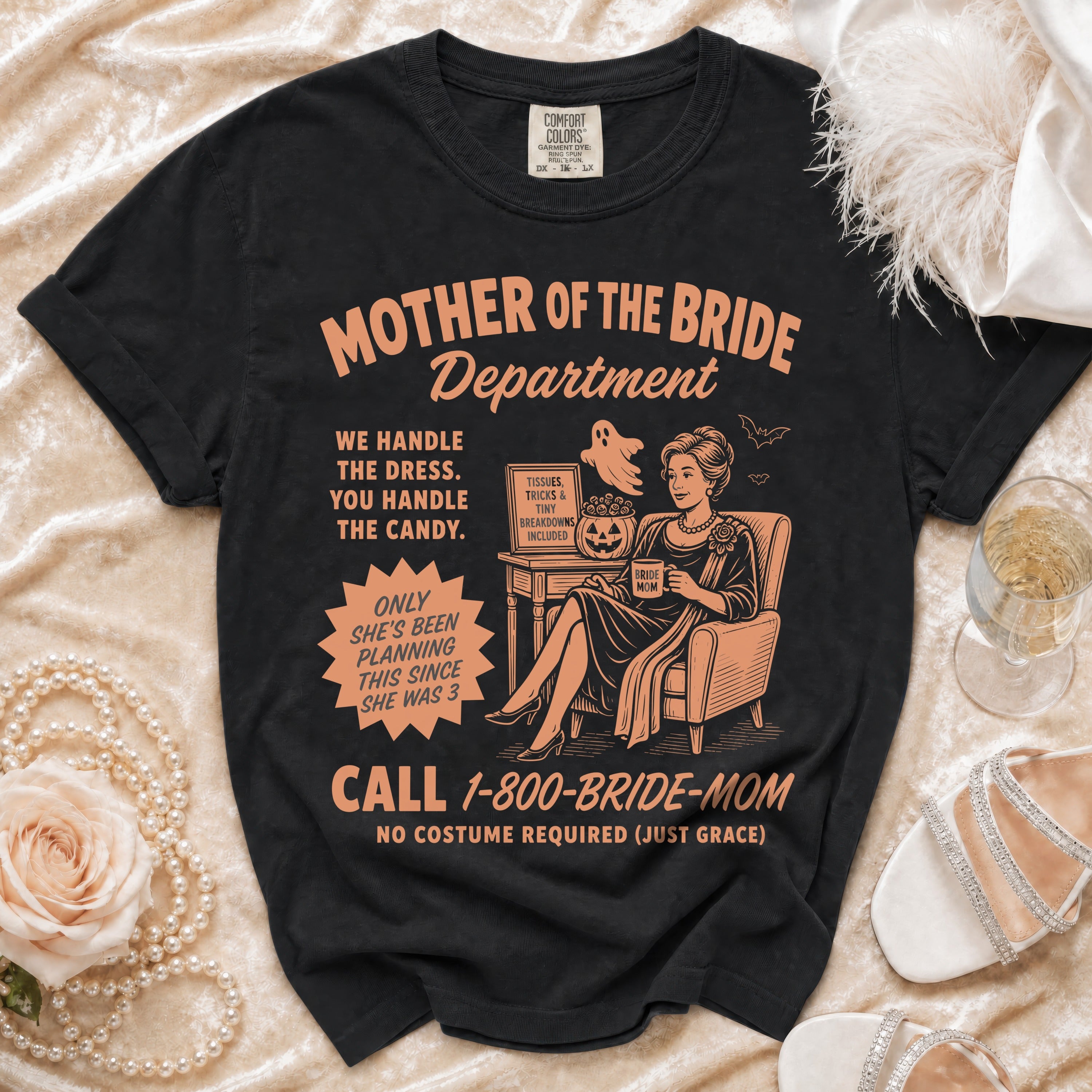 Black t-shirt with "Mother of the Bride Department" text and cartoon graphic.