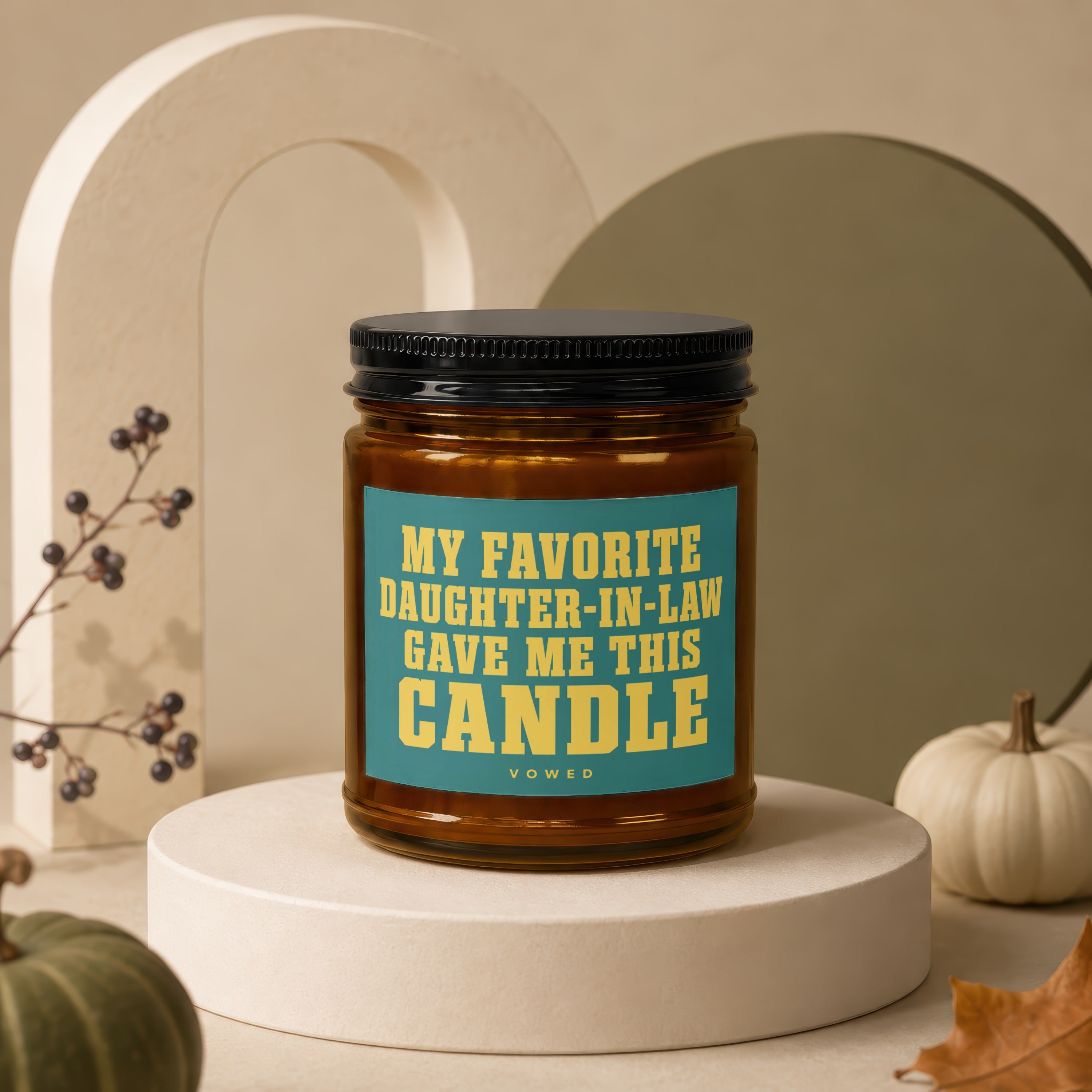 Amber candle with black lid and "My Favorite Daughter-In-Law Gave Me This Candle" text.