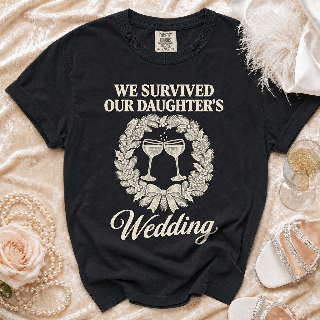 A black t-shirt featuring a Christmas wreath graphic and the text We Survived Our Daughter's Wedding.