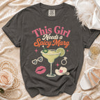 Graphic t-shirt with text "This Girl Needs a Spicy Marg" and margarita image.