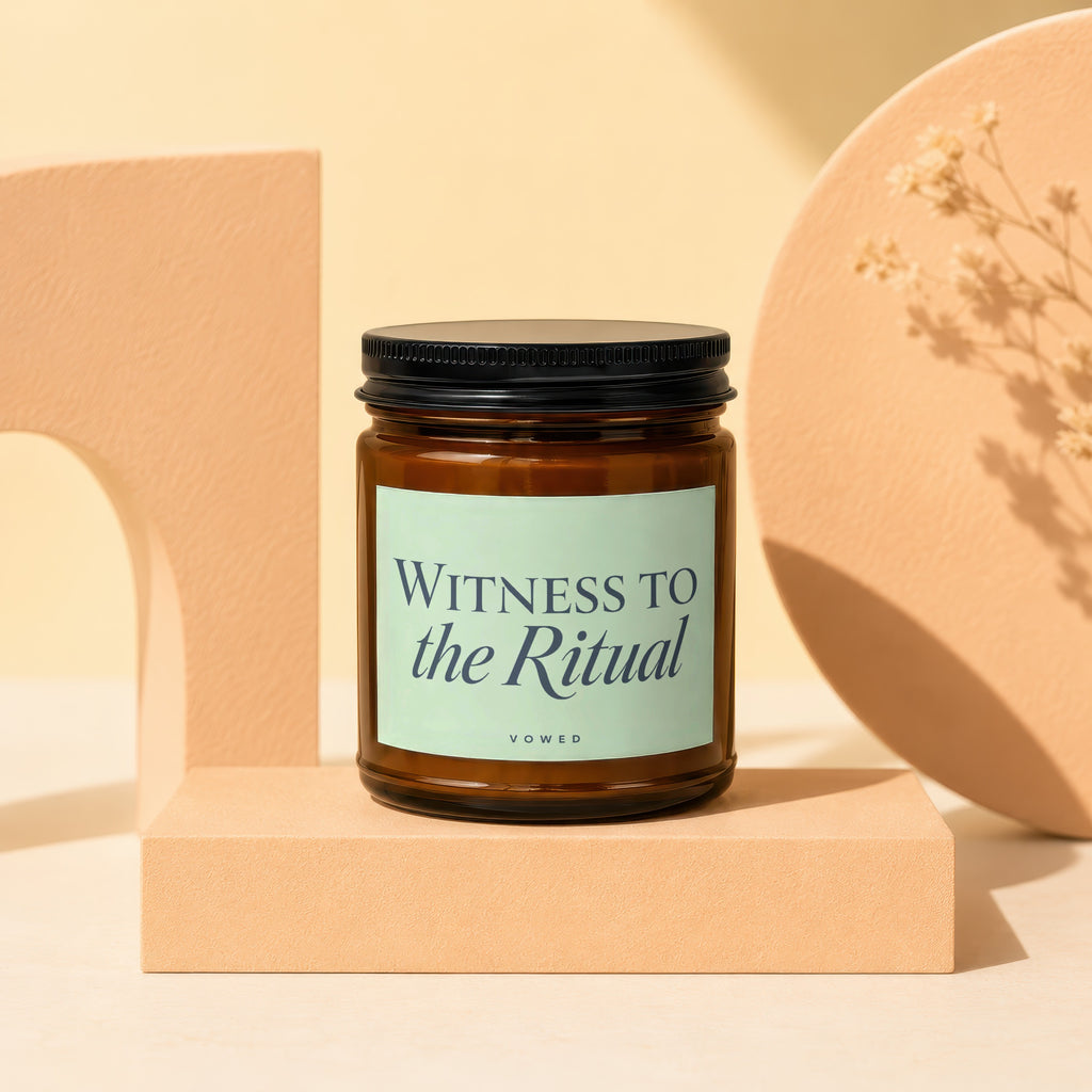 Amber glass candle with "WITNESS TO the Ritual" text on a light green label.