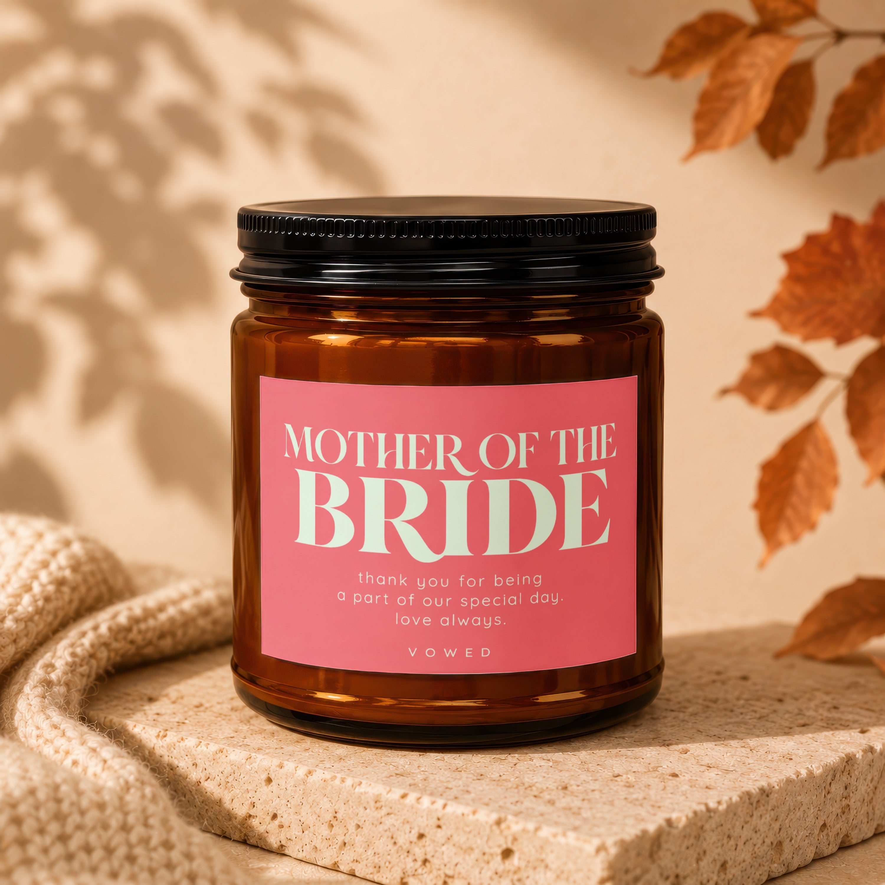 Amber candle with pink label reading "MOTHER OF THE BRIDE" and a thank you message.