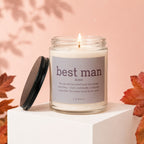 A lit glass candle jar labeled "best man noun" and its definition, with leaves and shadows.