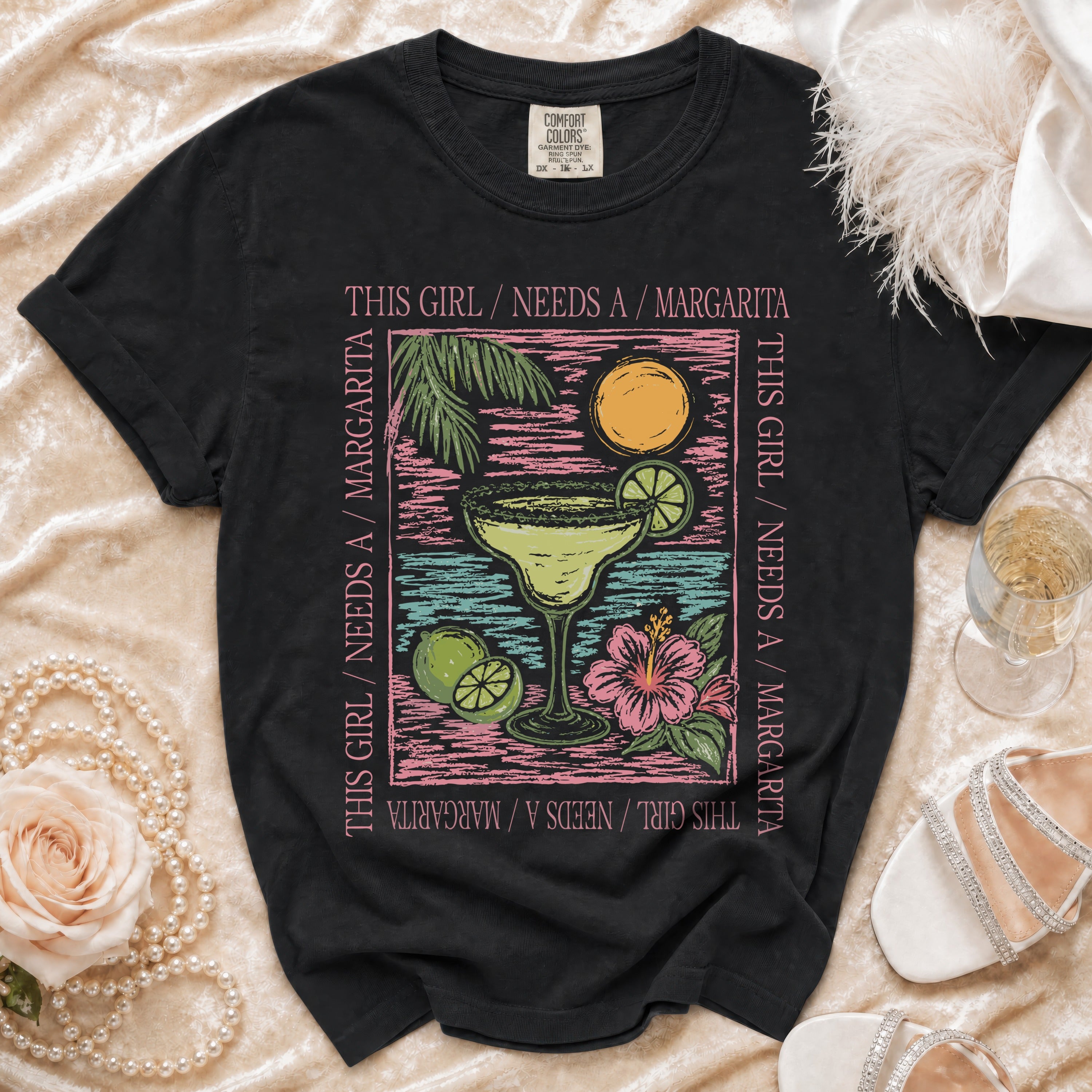 Black t-shirt with text "This girl needs a margarita" and margarita graphic.