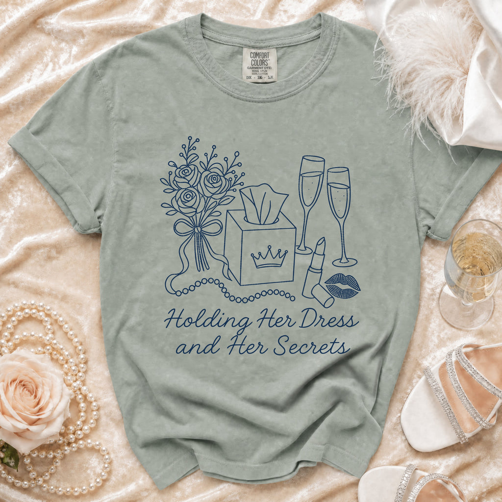 T-shirt with navy illustration of roses, tissue box, champagne glasses, lipstick, and text.