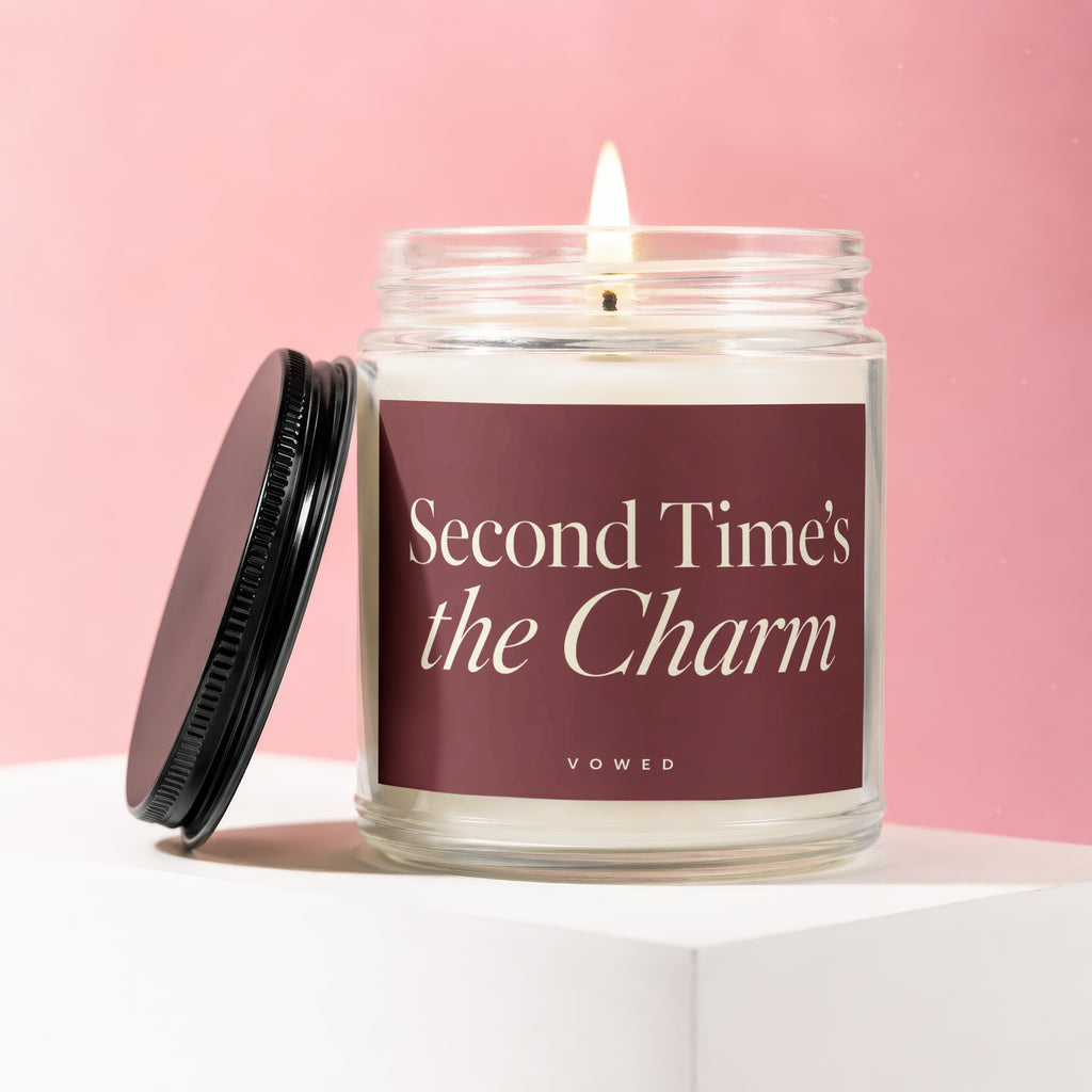 Candle with burgundy label reading "Second Time's the Charm" by Vowed.
