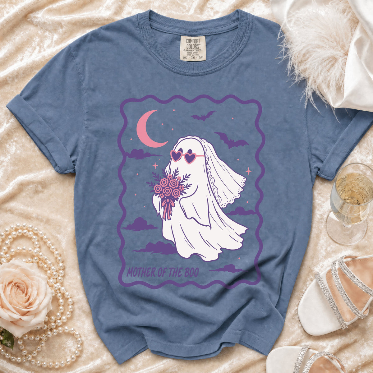 Blue t-shirt with a ghost bride wearing heart sunglasses and holding flowers, text reads "Mother of the Boo".
