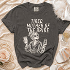 T-shirt with "Tired Mother of the Bride" text and graphic holding coffee and champagne.