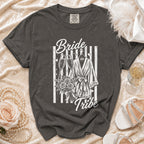 Grape t-shirt with "Bride Tribe" design featuring robe, champagne glasses, and bouquet.