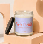 Glass candle with black lid and label reading "Worth The Wait"