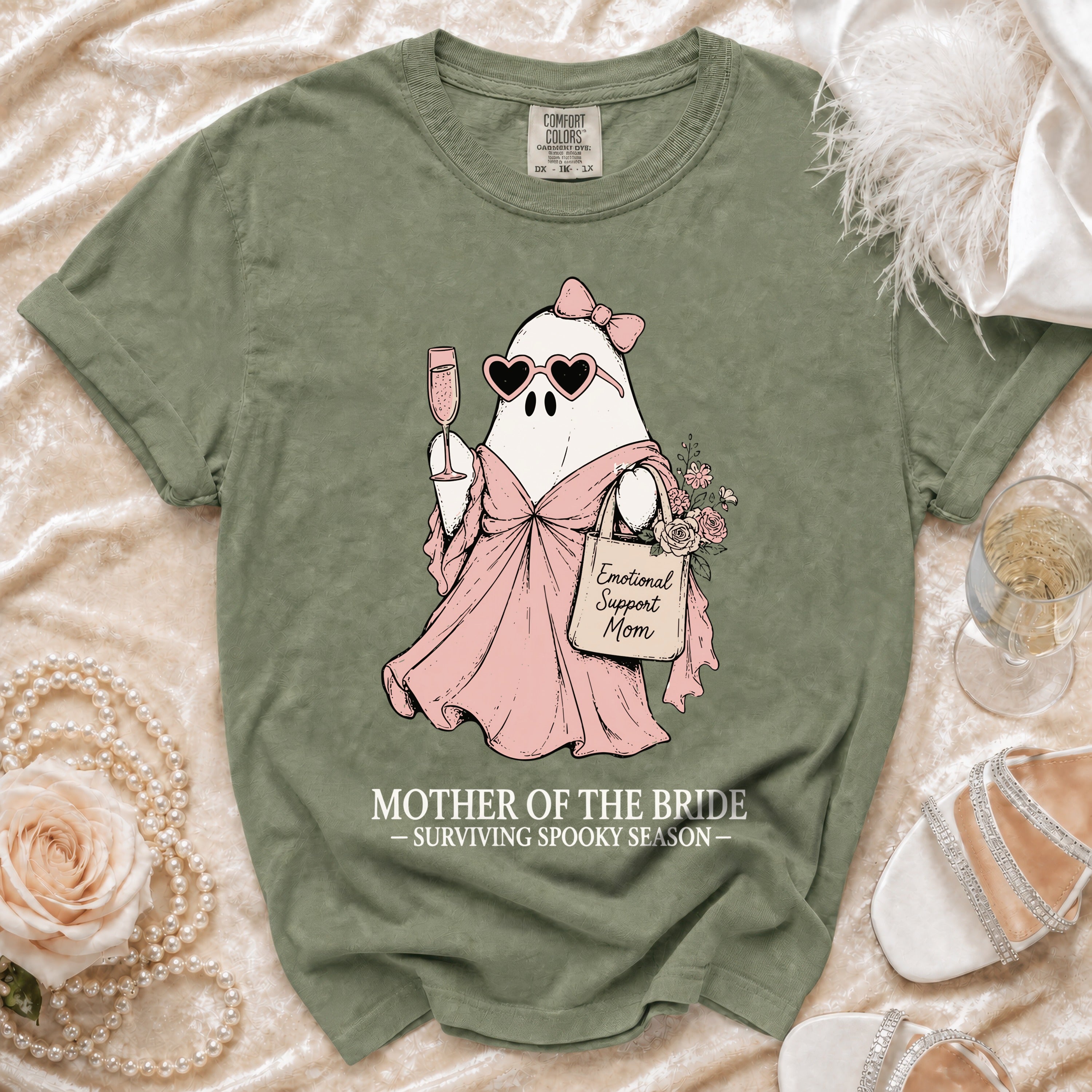 Green t-shirt with a ghost illustration holding champagne and a tote bag reading "Emotional Support Mom."