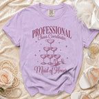 Purple t-shirt with "PROFESSIONAL Chaos Coordinator Maid of Honor" text and champagne glasses.
