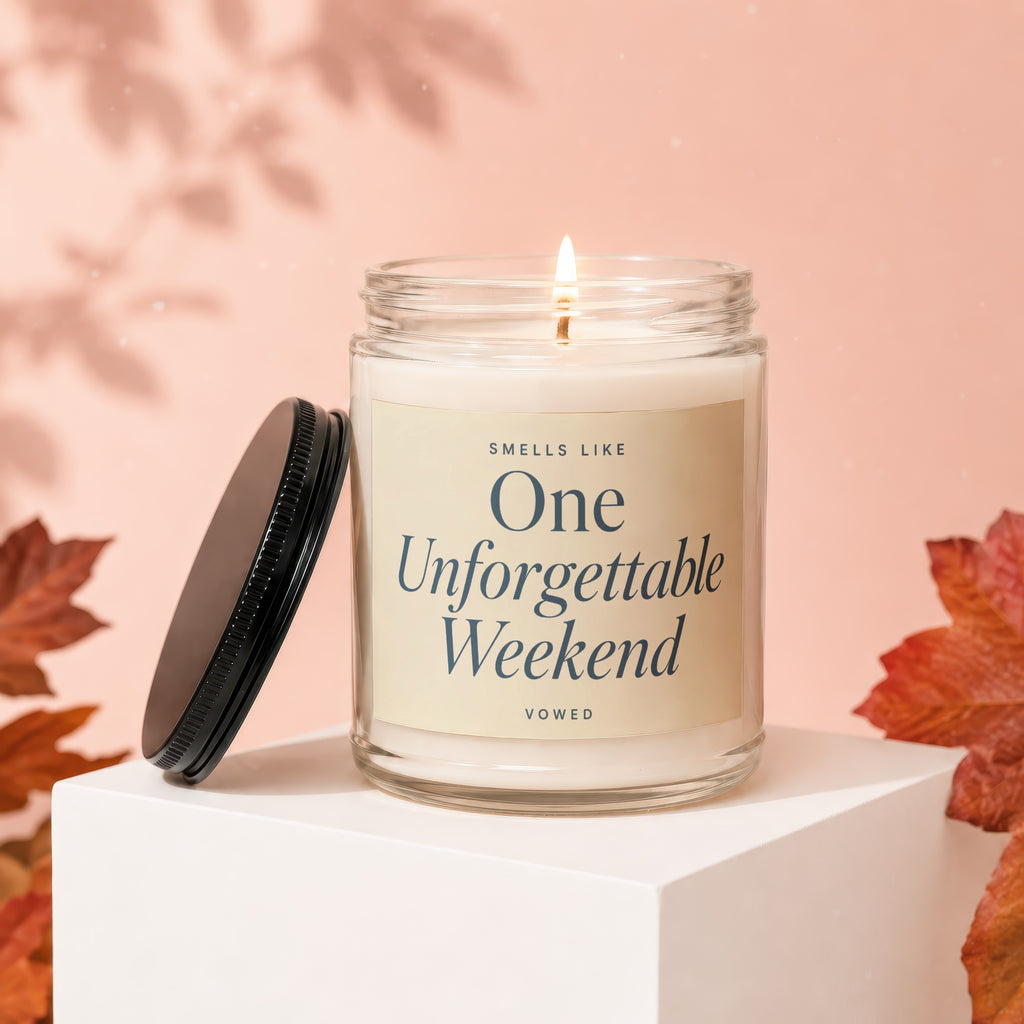Candle with label "Smells Like One Unforgettable Weekend" on display stand.