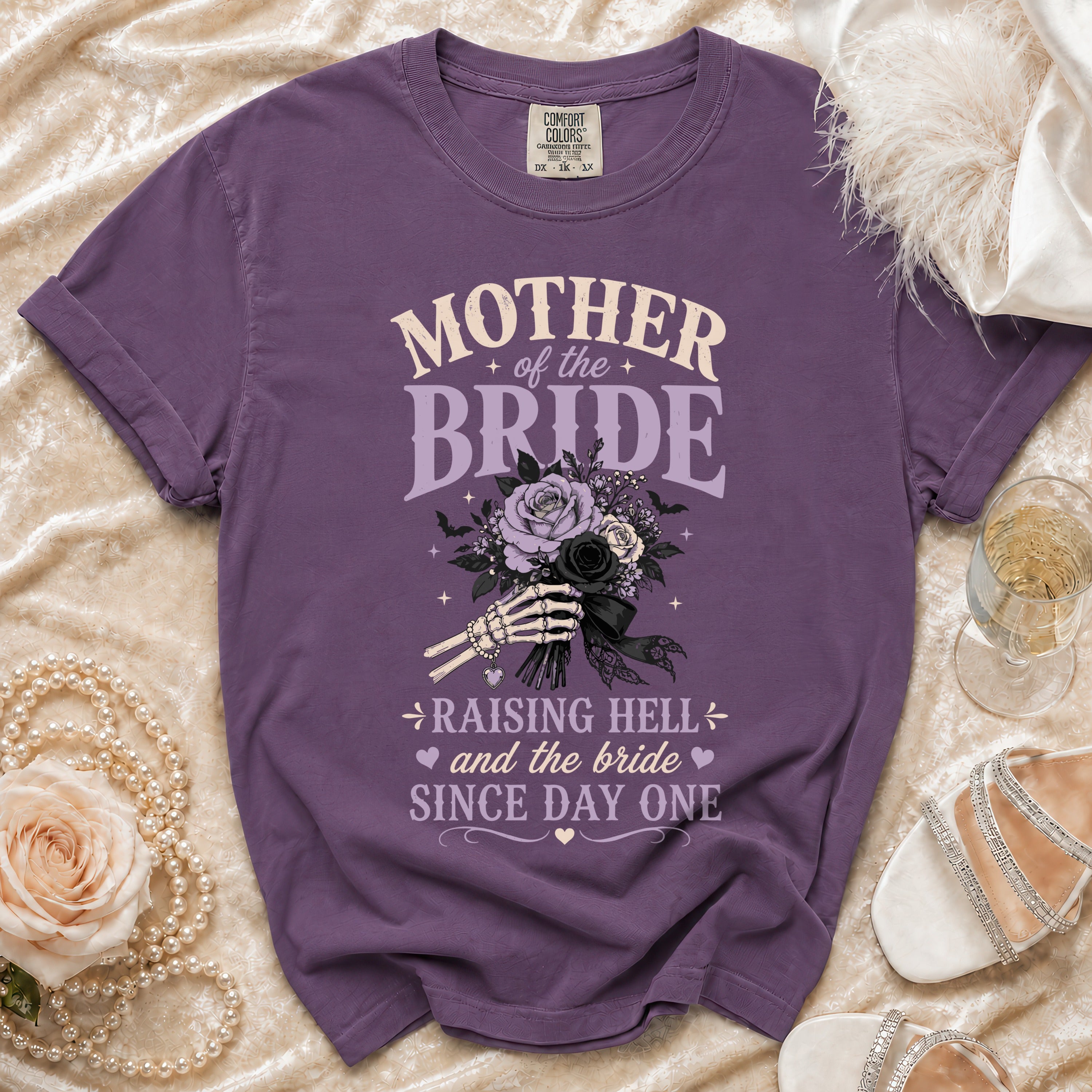 Purple crewneck t-shirt with Mother of the Bride text and a skeleton hand holding a bouquet.