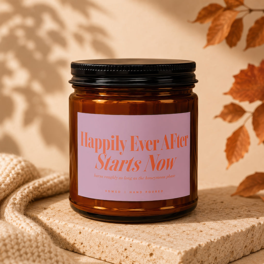 Amber jar candle with pink label reading "Happily Ever After Starts Now."