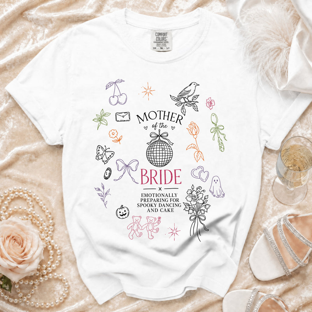 White t-shirt with "Mother of the Bride" and wedding-themed doodles.